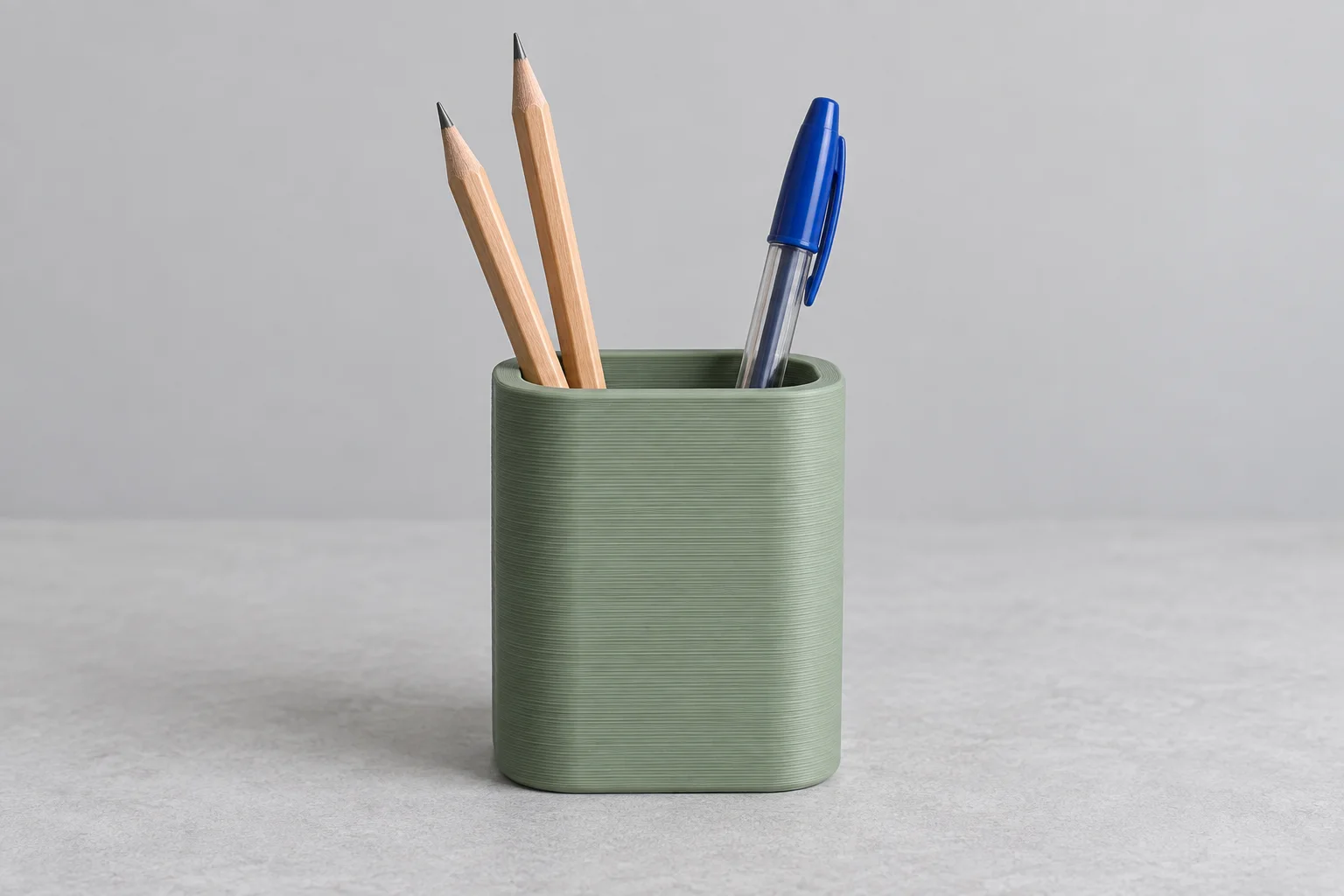 Illustrative printed desk holder containing pencils and a pen